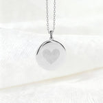 Danibydsgn Heart Fingerprint Pendant Necklace in 925 Sterling Silver displayed on soft white fabric, featuring two fingerprints elegantly engraved to form a heart — a minimalist and meaningful symbol of love and connection.