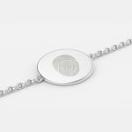 Minimal close-up of the Danibydsgn Single Fingerprint Coin Bracelet in 925 Sterling Silver, showing the engraved fingerprint design on a 16mm circular pendant connected to a fine chain, highlighting its smooth polish and elegant craftsmanship.