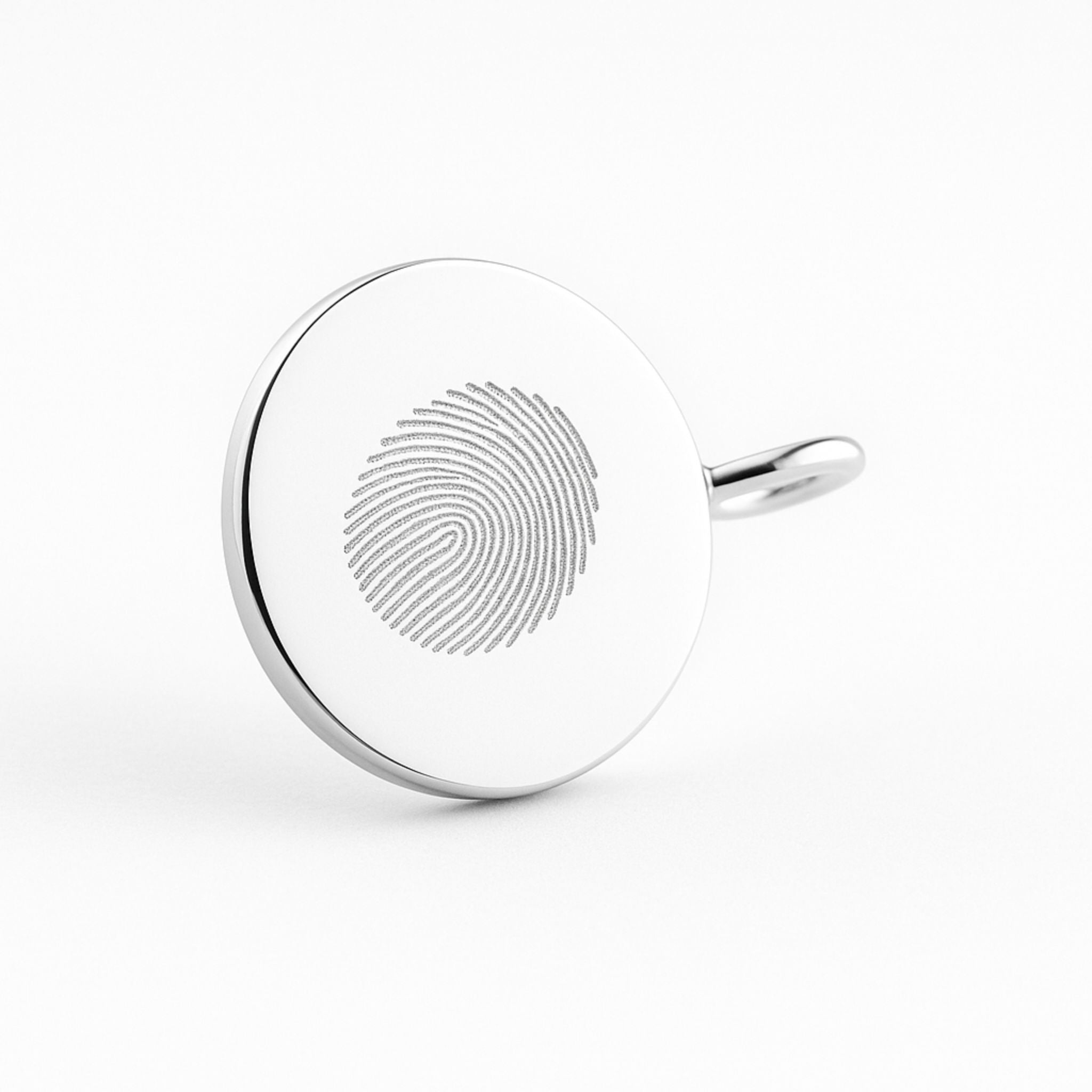 A close-up view of the Danibydsgn Single Fingerprint Coin Necklace in 925 Sterling Silver, highlighting the intricate diamond-engraved fingerprint. The polished silver surface reflects light beautifully, symbolising a cherished connection preserved in timeless craftsmanship.