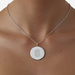 The Danibydsgn Single Fingerprint Coin Necklace in 925 Sterling Silver, shown worn on the neckline. The engraved fingerprint pendant rests gracefully against the skin, reflecting a personal connection and timeless elegance — a minimalist keepsake symbolising love, memory, and individuality.