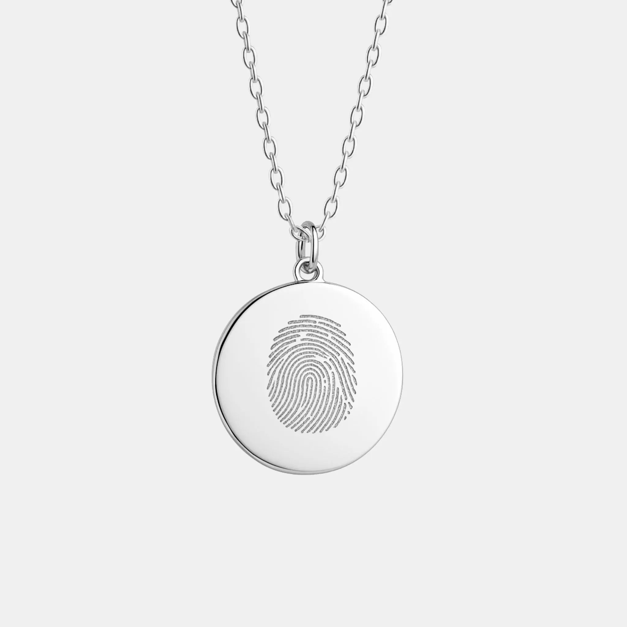 The Danibydsgn Single Fingerprint Pendant Necklace in 925 Sterling Silver — a minimalist round coin pendant featuring a finely engraved fingerprint design, symbolising love, memory, and personal connection in elegant handcrafted jewelry.