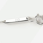 Close-up of the Danibydsgn branded tag and clasp on the 925 Sterling Silver fingerprint necklace, engraved with “DD” — a mark of authenticity and craftsmanship that reflects the brand’s commitment to timeless, luxury design.