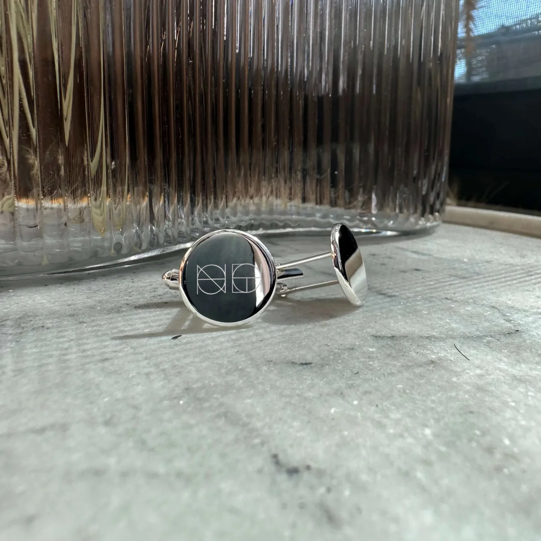 Engraved 925 sterling silver cufflinks by Danibydsgn, showcasing a mininalist, symbol design and polished finish from an angled view.