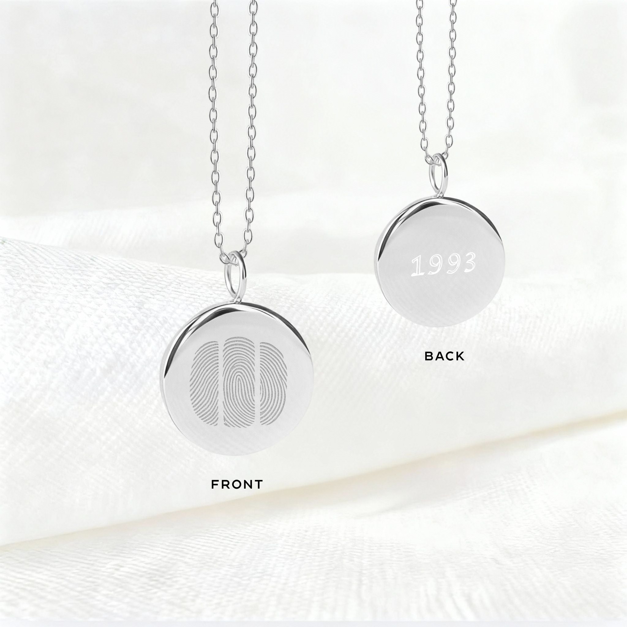 The Danibydsgn Three Fingerprint Coin Necklace in 925 Sterling Silver, showing the front with three engraved fingerprints symbolising family connection and the back engraved with a birth year — a timeless keepsake celebrating love and legacy.
