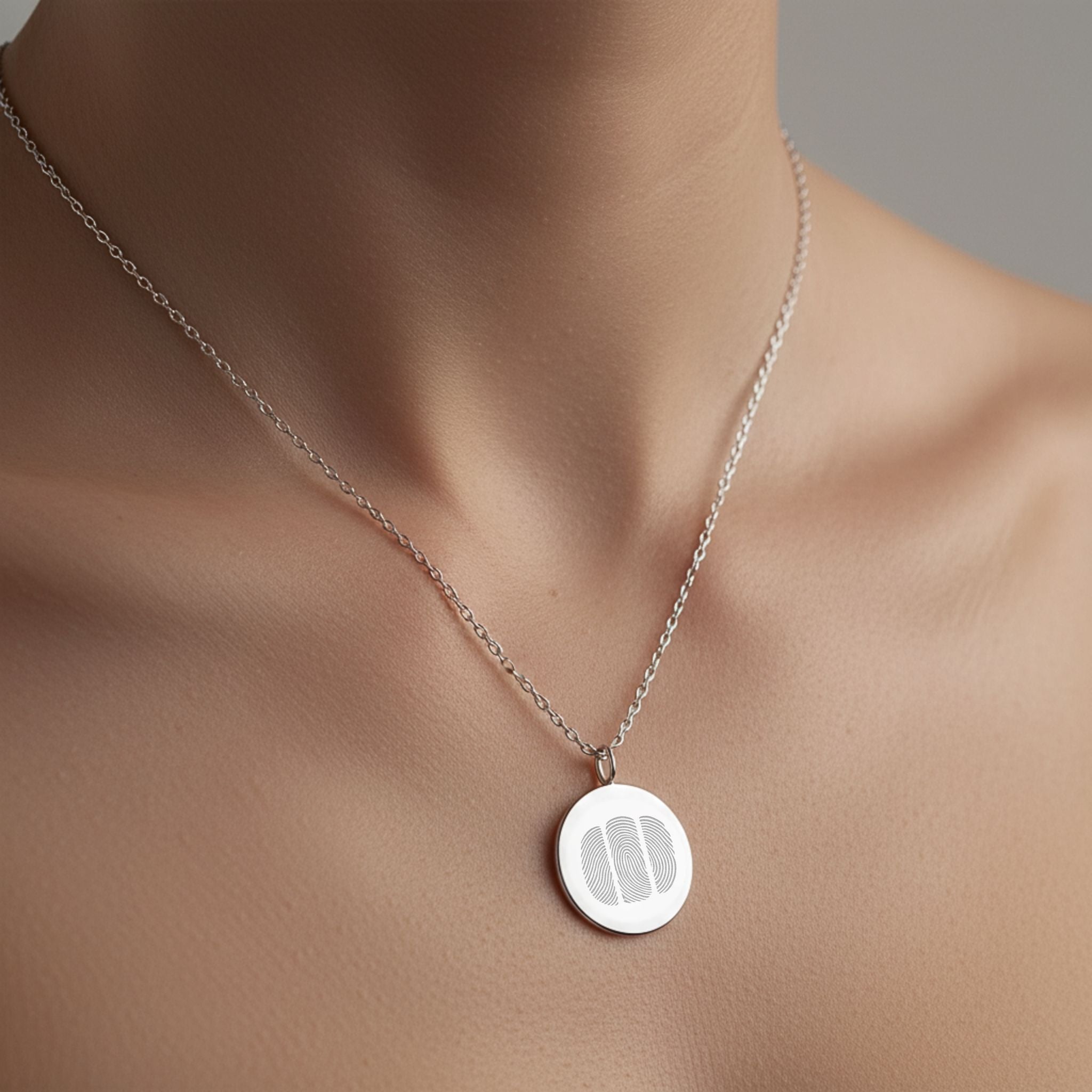 Model wearing the Danibydsgn Three Fingerprint Coin Necklace in 925 Sterling Silver, showcasing its minimalist elegance and three engraved fingerprints that represent deep emotional bonds and timeless connection.