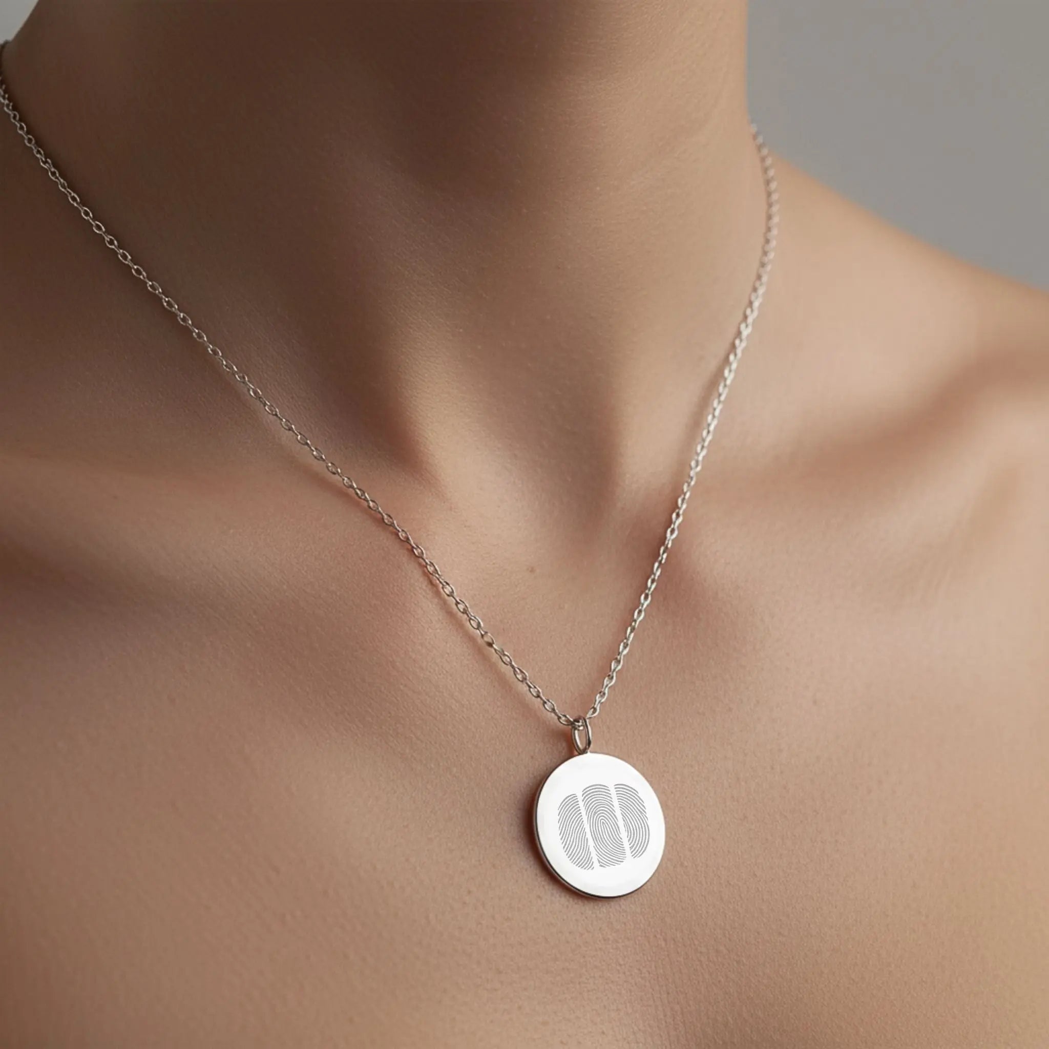 Model wearing the Danibydsgn Three Fingerprint Coin Necklace in 925 Sterling Silver, showcasing its minimalist elegance and three engraved fingerprints that represent deep emotional bonds and timeless connection.