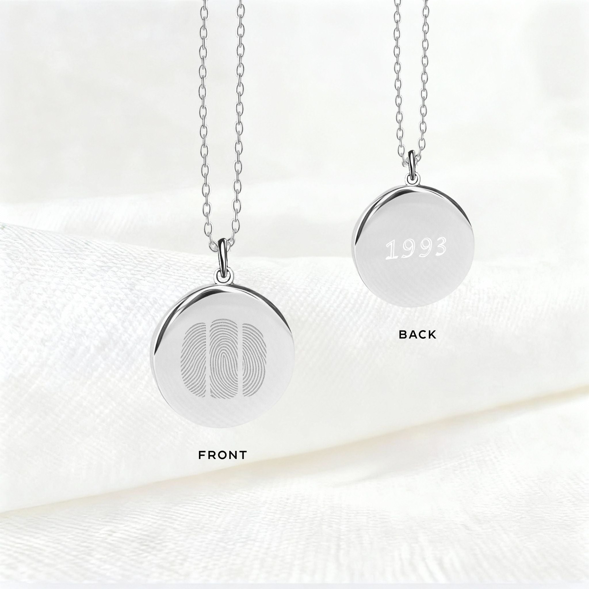 Front and back view of the Danibydsgn Three Fingerprint Pendant Necklace in 925 Sterling Silver, featuring three engraved fingerprints on the front and personalized engraving with the year “1993” on the back — a meaningful custom keepsake of love and family.