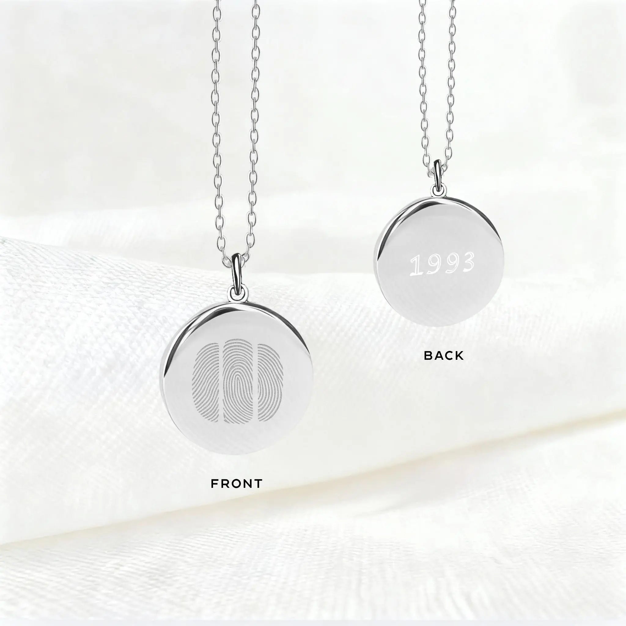 Front and back view of the Danibydsgn Three Fingerprint Pendant Necklace in 925 Sterling Silver, featuring three engraved fingerprints on the front and personalized engraving with the year “1993” on the back — a meaningful custom keepsake of love and family.