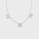 Danibydsgn three-symbol necklace in 925 sterling silver, featuring three custom cut-out symbol pendants spaced on a fine chain (front view).