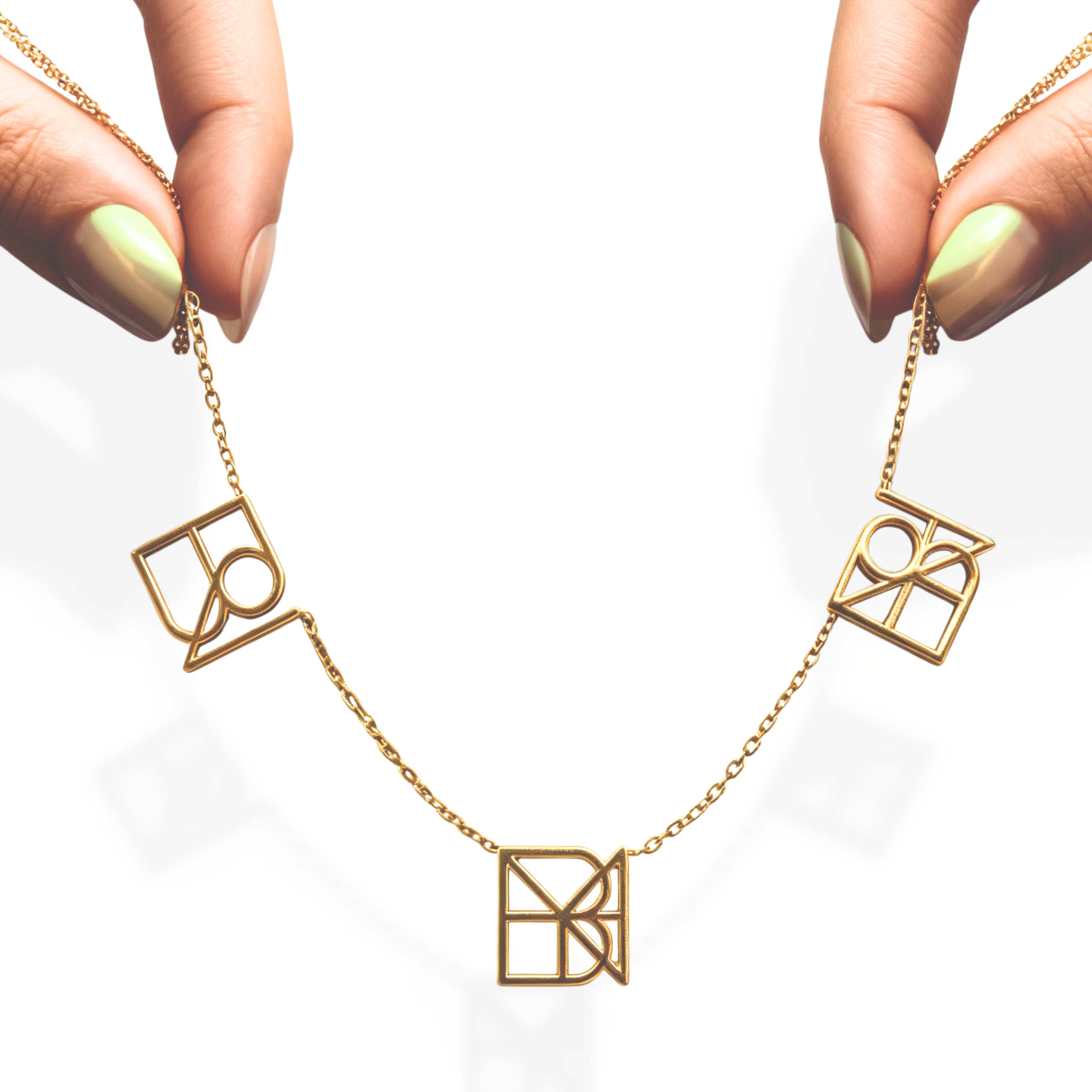 danibydsgn three symbol necklace held up by elegant fingers – personalized 9k yellow gold triple pendant necklace, luxury custom name necklace, bespoke custom jewelry