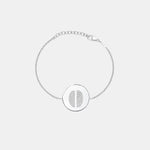 Minimal studio shot of the Danibydsgn Two Fingerprint Coin Bracelet in 925 Sterling Silver, featuring a polished 16mm round pendant engraved with two fingerprints and an adjustable diamond-cut chain for a refined, personal look.