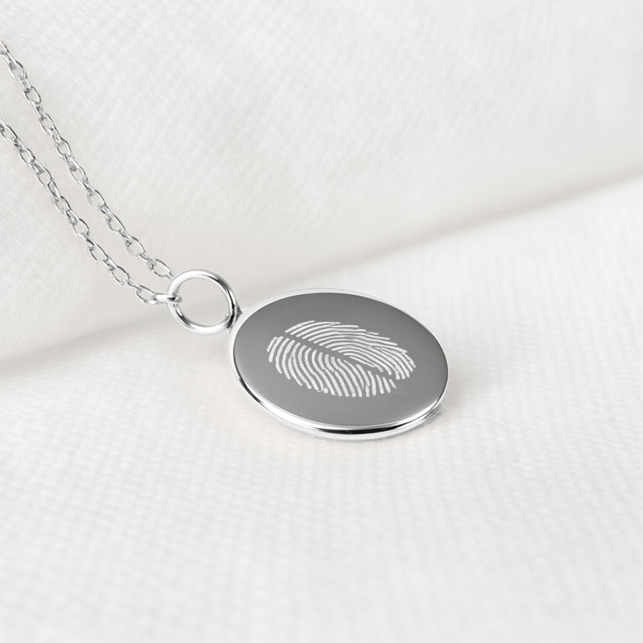 Close-up of the Danibydsgn Two Fingerprint Coin Necklace in 925 Sterling Silver, featuring finely diamond-engraved fingerprints symbolising two loved ones — a timeless keepsake of connection, love, and craftsmanship.