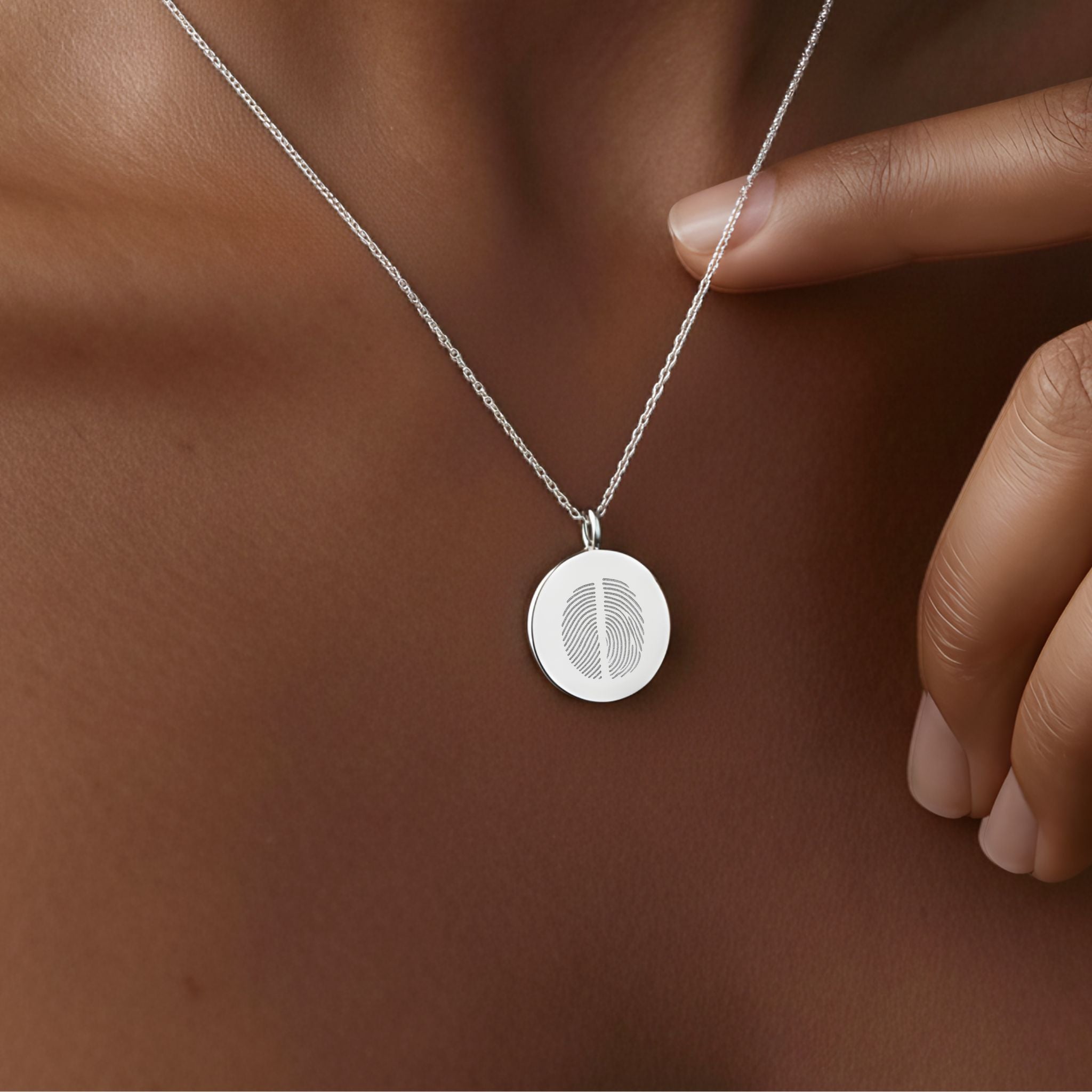 Close-up of the Danibydsgn Two Fingerprint Coin Necklace in 925 Sterling Silver resting gracefully against the skin — a meaningful piece symbolizing the unbreakable bond between two loved ones, blending sentiment and refined elegance