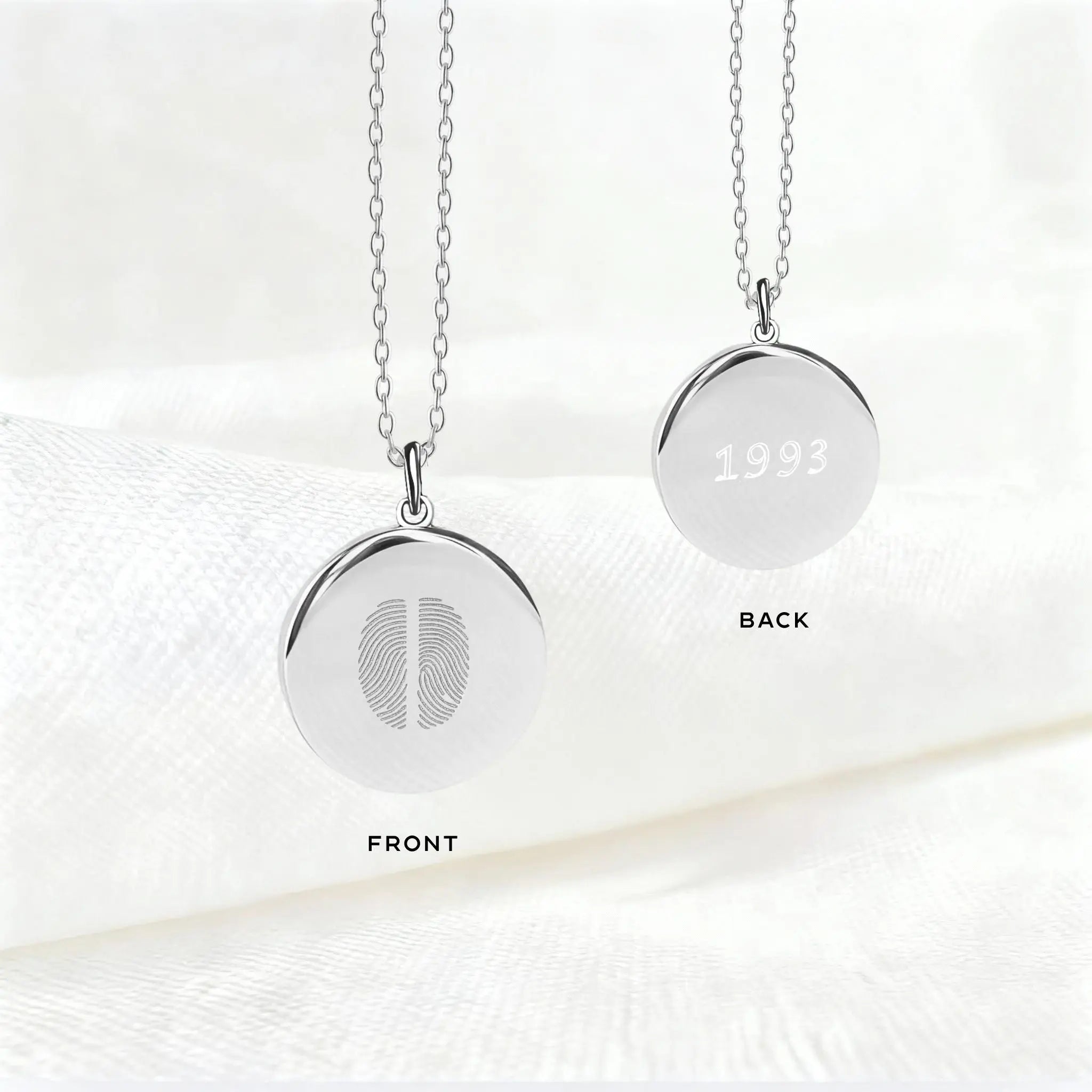 Front and back view of the Danibydsgn Two Fingerprint Pendant Necklace in 925 Sterling Silver, featuring two engraved fingerprints on one side and personalized engraving with the year “1993” on the reverse — a timeless, custom keepsake.