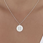 Model wearing the Danibydsgn Two Fingerprint Pendant Necklace in 925 Sterling Silver, featuring two engraved fingerprints on a polished coin pendant that rests gracefully on the collarbone — a modern keepsake of love and connection.