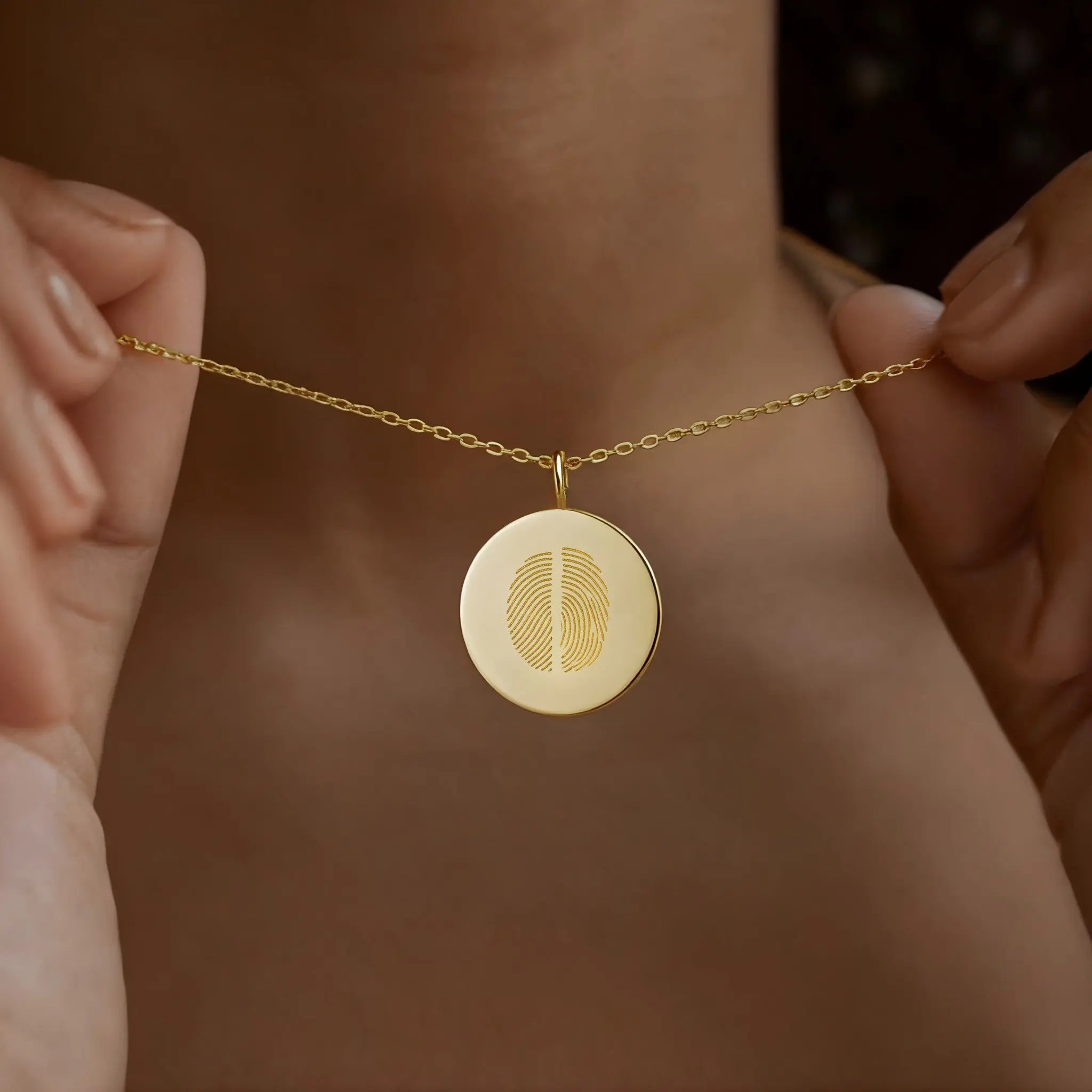 Duo fingerprint pendant necklace in 18K gold vermeil by Danibydsgn, worn close to the neck. Features dual engraved fingerprints symbolizing connection and love. A handcrafted, luxury personalized keepsake perfect for meaningful gifting or everyday elegance.