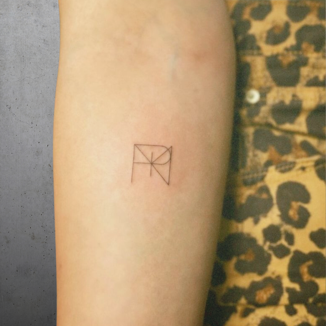Minimalist premade logo tattoo design by Danibydsgn, featuring a clean geometric-style symbol inspired by English letters, ideal for flash tattoos or personal logo symbolism.