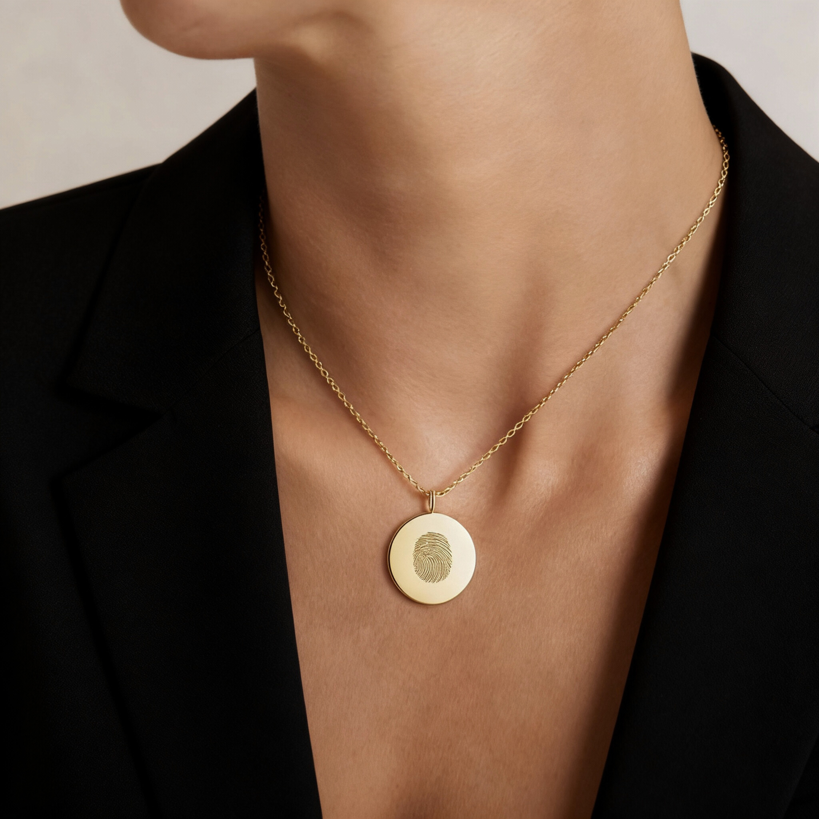 Model wearing the Single Fingerprint Coin Necklace in 18k Gold Vermeil by Danibydsgn — a minimalist piece of luxury fine jewelry featuring a detailed fingerprint engraving on a polished gold coin pendant.