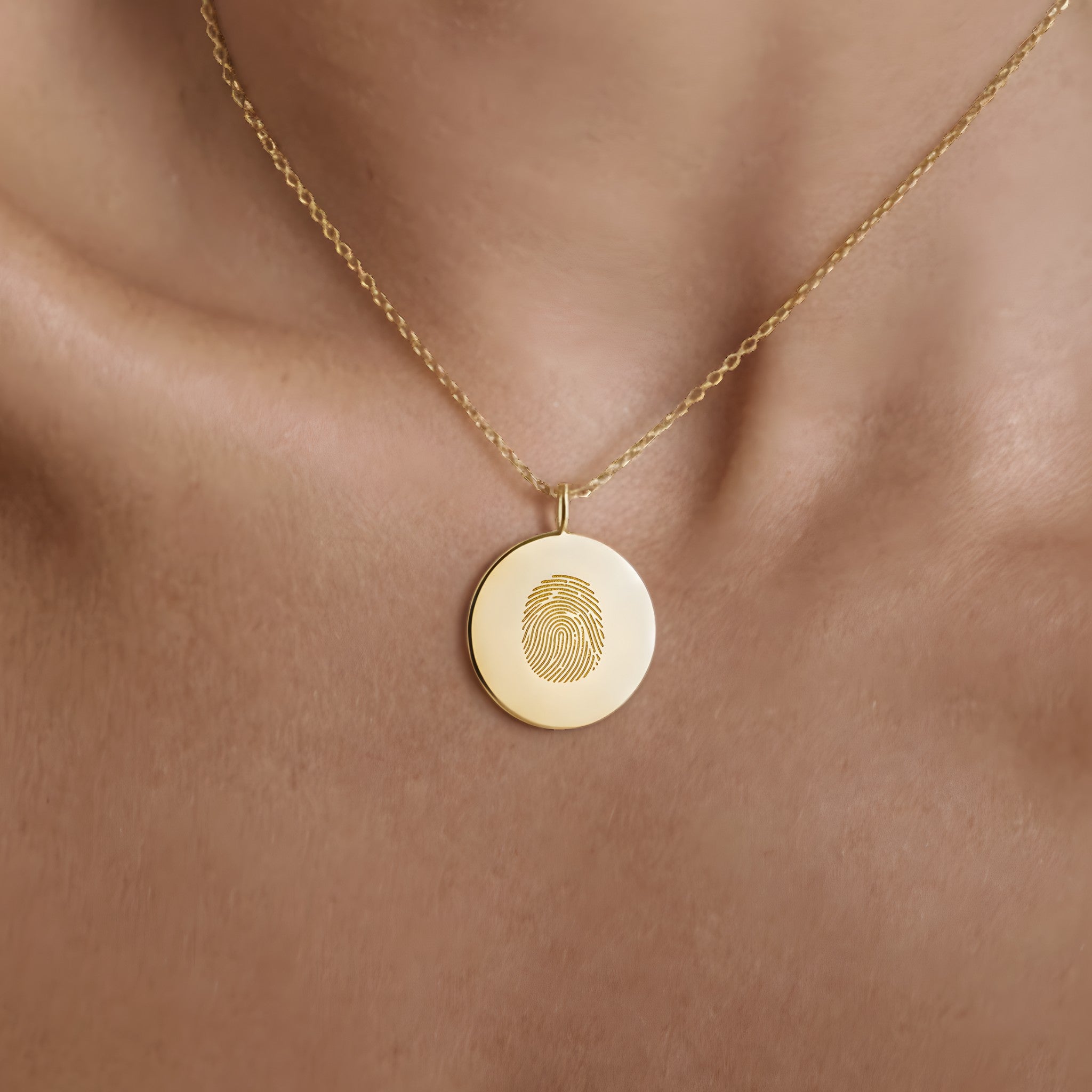 Model wearing the Single Fingerprint Coin Necklace in 18k Gold Vermeil by Danibydsgn — a luxury personalized necklace featuring a finely engraved fingerprint pendant that embodies love, connection, and individuality.