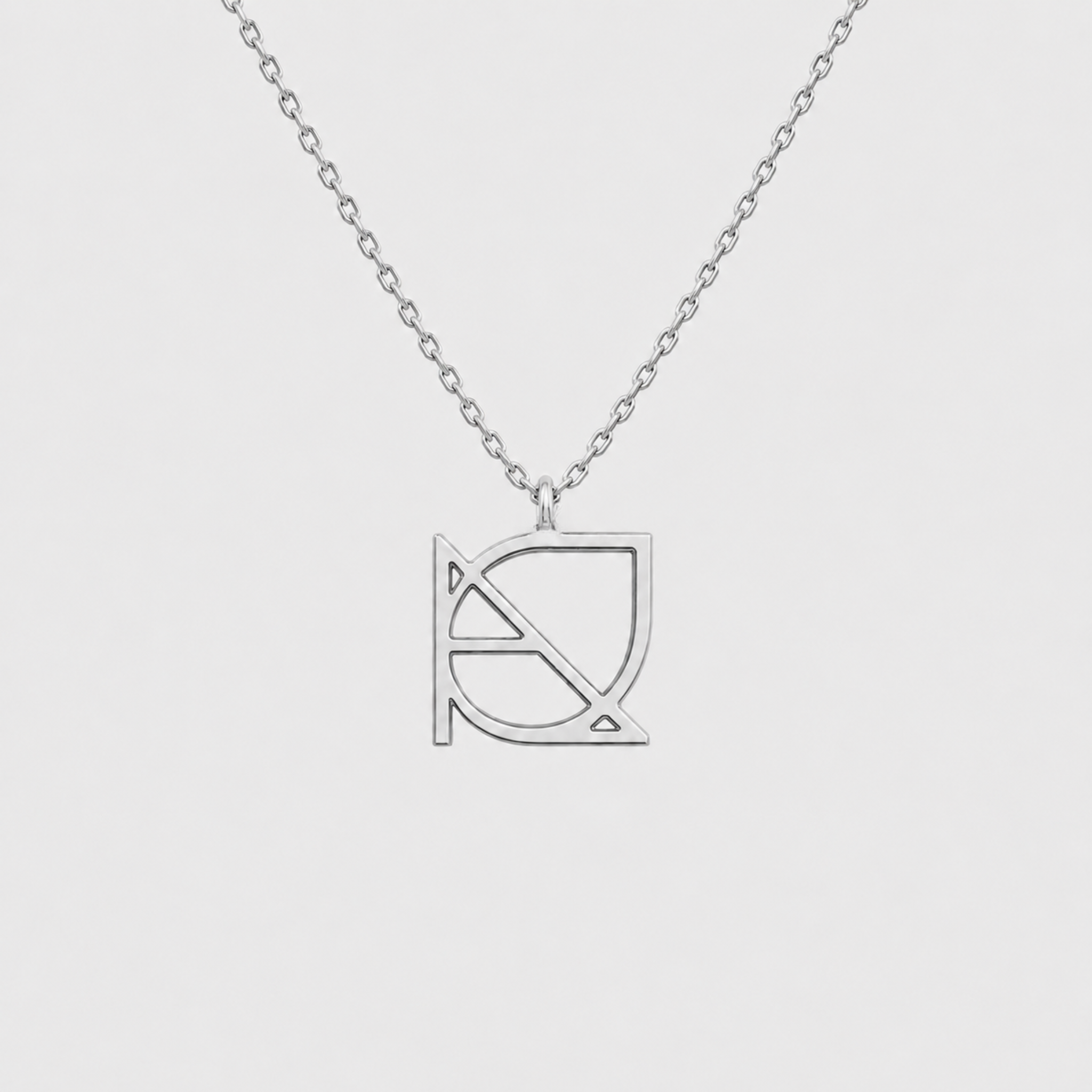 A custom necklace made of 925 sterling silver, showcasing a hand-designed piece of symbol jewelry with a fine cut out jewelry pendant hanging from a central jump ring.