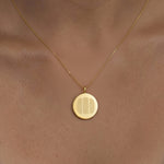 Model wearing the Luxury Three Fingerprint Coin Necklace in 18K Gold Vermeil by Danibydsgn. The engraved triple fingerprint design sits elegantly against the skin, symbolizing lasting connection and love. A modern, personalized heirloom crafted in radiant gold vermeil for everyday luxury.