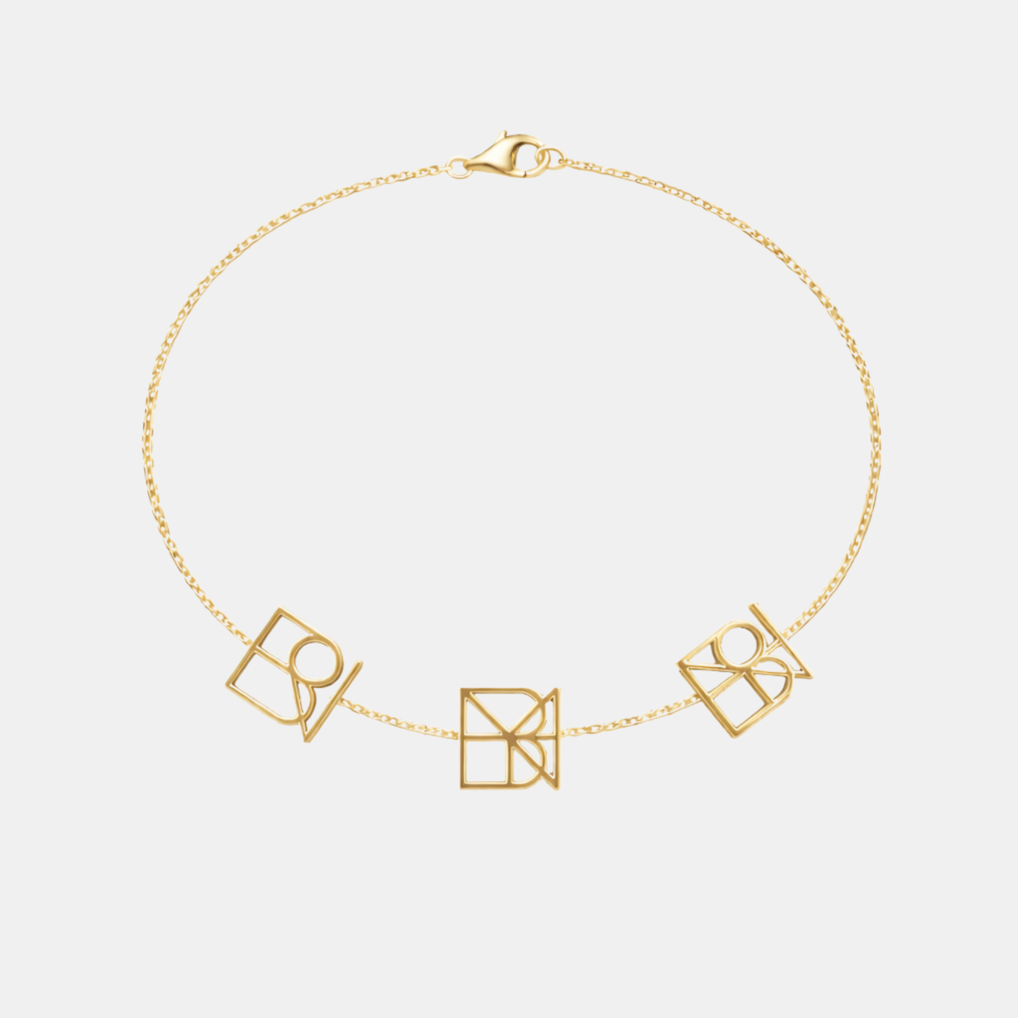 Custom 9k gold bracelet featuring three unique bespoke geometric symbols on a solid gold fine chain.