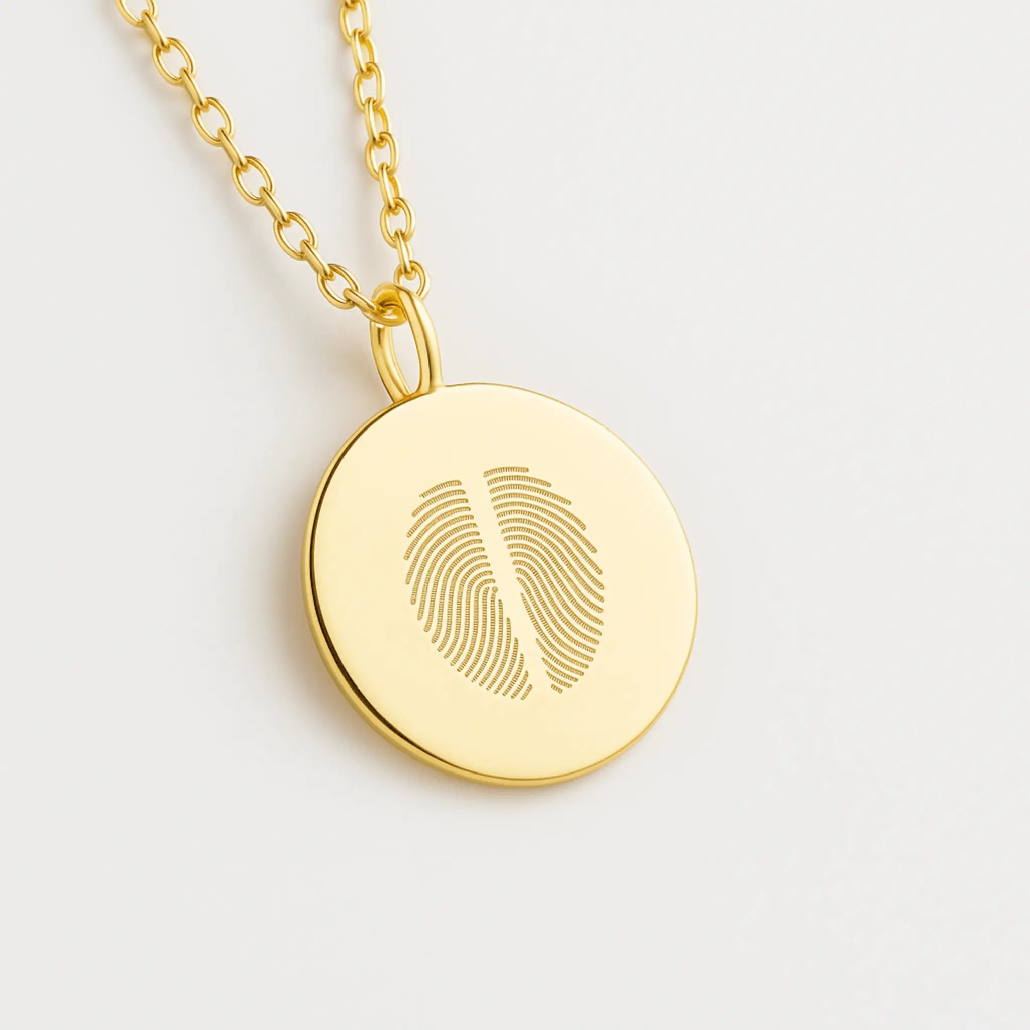 Close-up of the Two Fingerprint Coin Necklace in 18k Gold Vermeil by Danibydsgn — luxury personalized jewelry with dual engraved fingerprints on a polished gold pendant.
