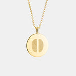 Two Fingerprint Coin Necklace in 18k Gold Vermeil by Danibydsgn — luxury custom jewelry featuring dual engraved fingerprints on a polished round gold pendant.
