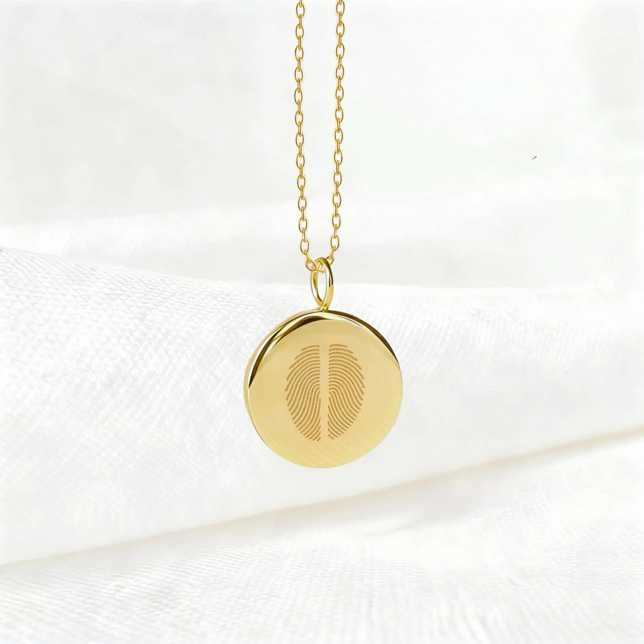 Two fingerprint pendant necklace in 18K gold vermeil by Danibydsgn, suspended elegantly against a soft white background. Features dual engraved fingerprints on a polished disc — a timeless, luxury keepsake symbolizing connection, unity, and bespoke craftsmanship.