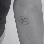 Joined fine line custom logo and tattoo design for two names featuring interlocking geometric symbol artwork tattooed on a person inner arm.