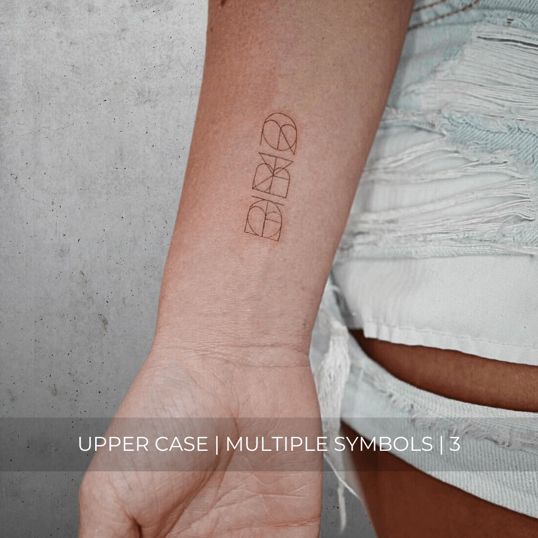A minimalistic fine line tattoo of an overlapping Custom Logos design on a person's inner arm of a three symbol design in uppercase letters, exemplifying custom logo design, name tattoo design, and body art. This simple tattoo idea showcases personal branding and tattoo art, ideal for both name logos and wall art applications.