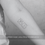 A minimalistic fine line tattoo of an overlapping Custom Logos design on a person's inner arm of a two symbol design in uppercase letters, exemplifying custom logo design, name tattoo design, and body art. This simple tattoo idea showcases personal branding and tattoo art, ideal for both name logos and wall art applications.