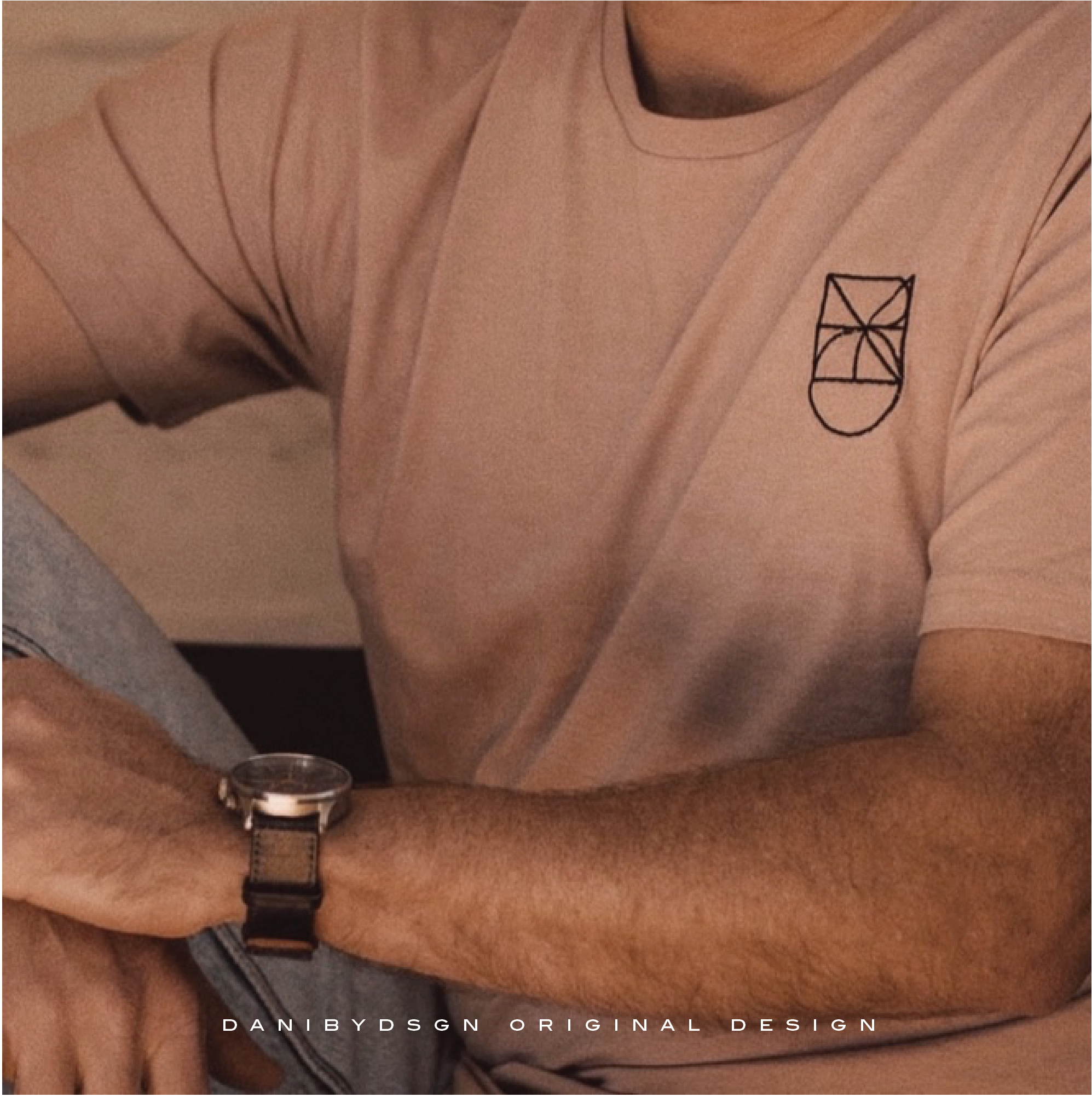 A sophisticated embroidered monogram design featuring personalized initials with fine line details and a minimalist approach on a beige round neck  shirt