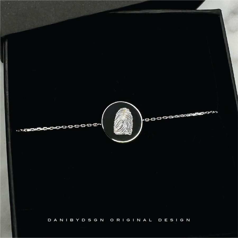 A personalized fingerprint pendant that can be customized with the fingerprint of a spouse, child, or other loved one, creating a meaningful and sentimental gift